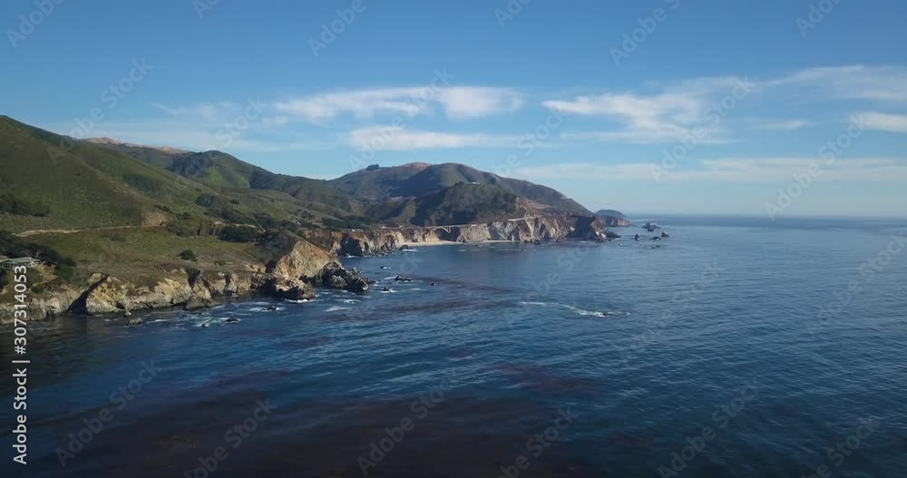Aerial Shot of The Bixby Creek Bridge in the Distance Along the Coast of California | The Big Sur Aerial Shot of The Bixby Creek Bridge in the Distance Along the Coast of California | The Big Sur