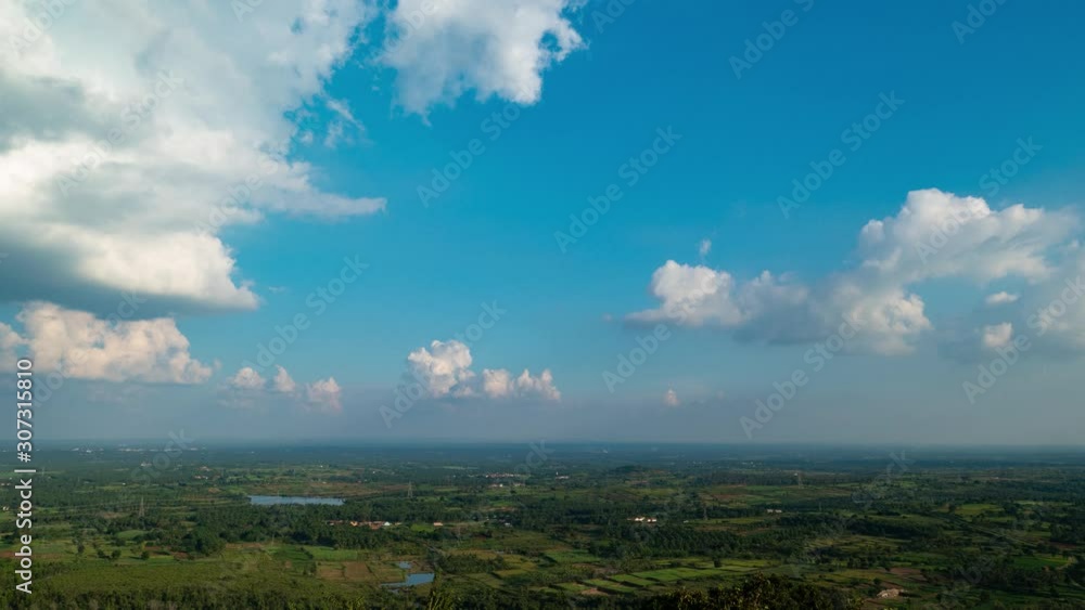Time lapse of passing clouds over a huge landscape, viewed from the top of a mountain. Time lapse of passing clouds over a huge landscape, viewed from the top of a mountain.