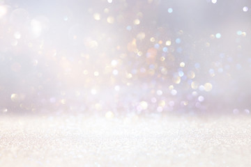 abstract background of glitter vintage lights . silver, gold and white. de-focused