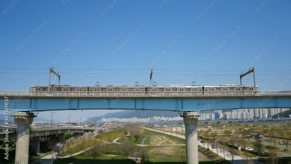 Elevated rail metro system travel across over the elevated highway of Busan city. Infrastructure transport in Busan, South Korea. Elevated rail metro system travel across over the elevated highway of Busan city. Infrastructure transport in Busan, South Korea.