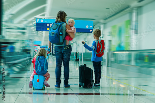 mother with kids travel in airport, family travel
