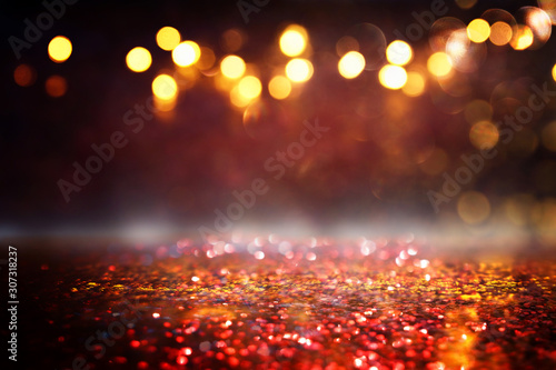 background of abstract red, gold and black glitter lights. defocused