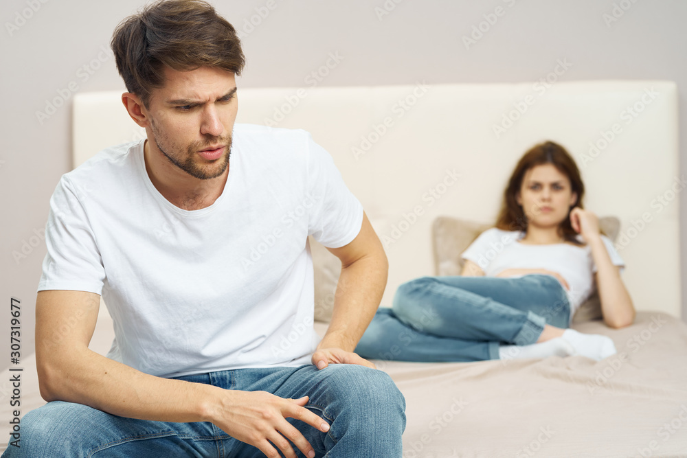 young couple sitting on sofa watching tv young couple sitting on sofa watching tv