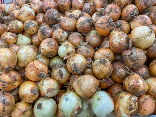 Big pile of brown onion for sale at farmers' market