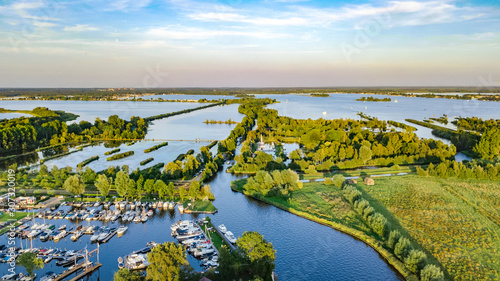 Canvas Print Aerial drone view of typical Dutch landscape with canals, polder water, green fi