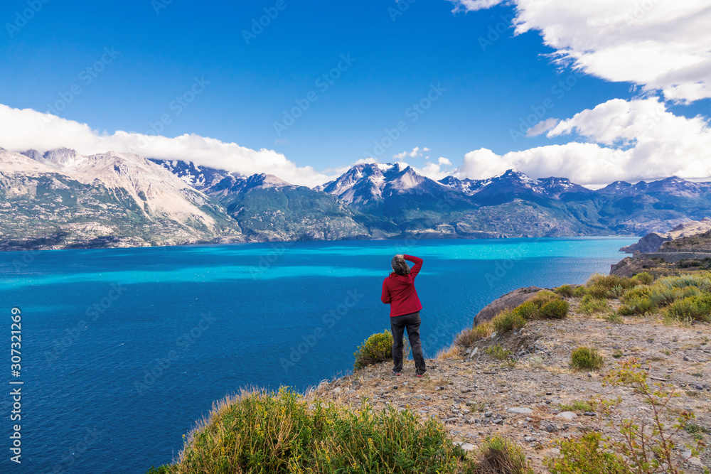 Woman tourist hiking, Chile travel, Bertran lake and mountains beautiful landscape, Chile, Patagonia, South America