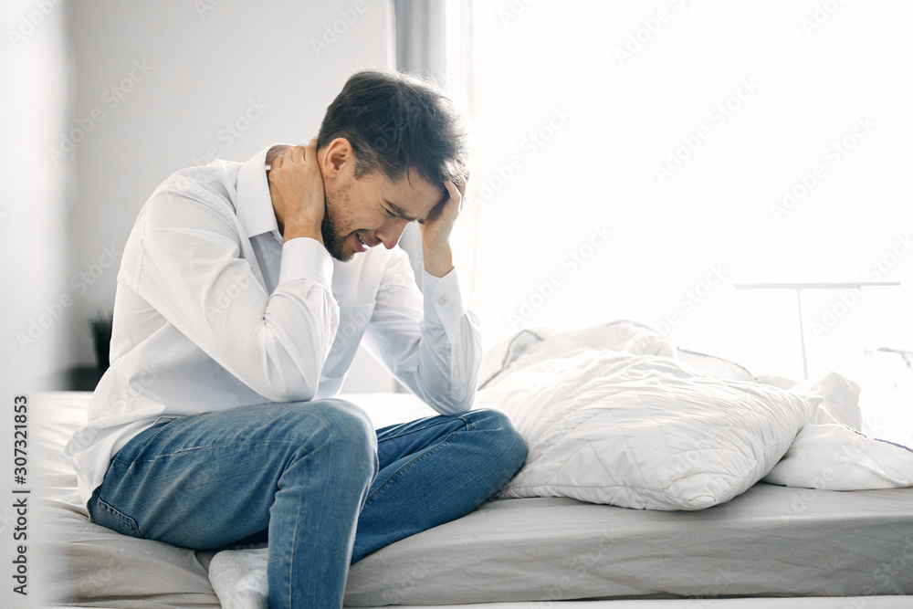 young man sitting on sofa at home young man sitting on sofa at home