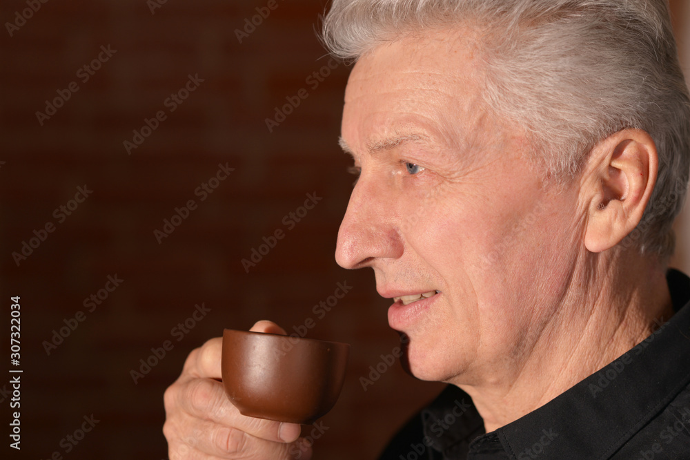Portrait of senior man drinking cup of coffee Portrait of senior man drinking cup of coffee
