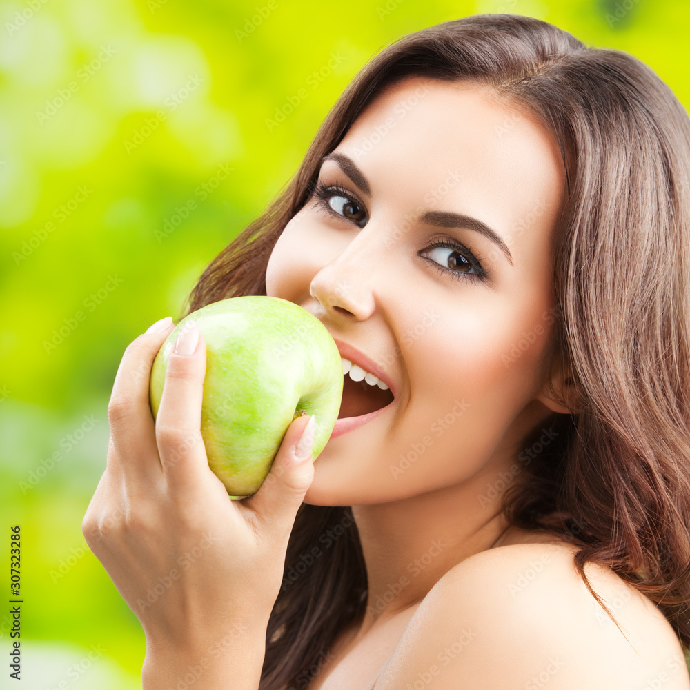Young happy smiling lovely brunette woman with green apple Young happy smiling lovely brunette woman with green apple
