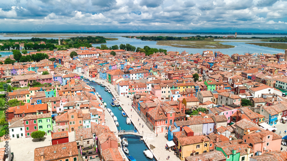 Aerial view of colorful Burano island in Venetian lagoon sea from above, Italy