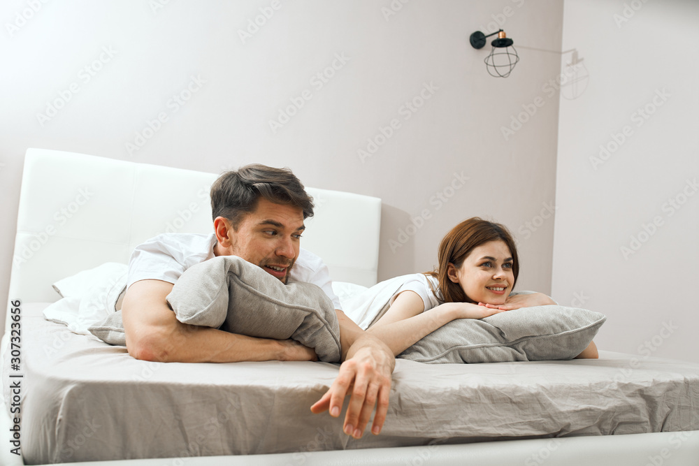 Fototapeta premium young couple lying on sofa