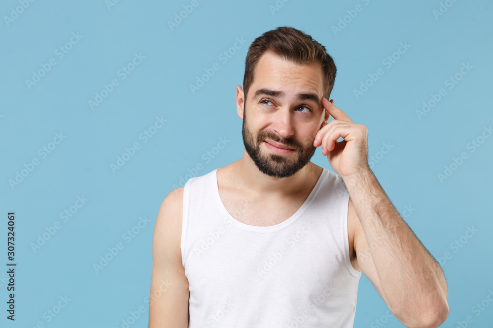 Close up bearded young man 20s years old perfect skin wearing white shirt isolated on blue pastel wall background, studio portrait. Skin care healthcare cosmetic procedures concept. Mock up copy space Close up bearded young man 20s years old perfect skin wearing white shirt isolated on blue pastel wall background, studio portrait. Skin care healthcare cosmetic procedures concept. Mock up copy space