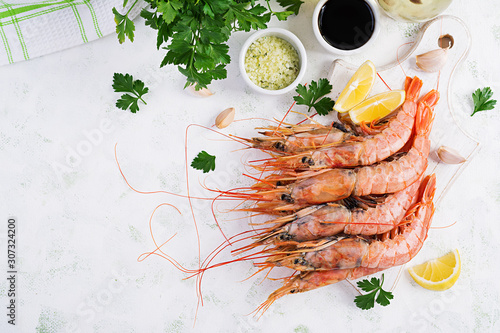 Raw wild Argentinian red shrimps/prawns  and ingredients for cooking. Delicious food. Keto / Paleo Diet. Top view, overhead photo