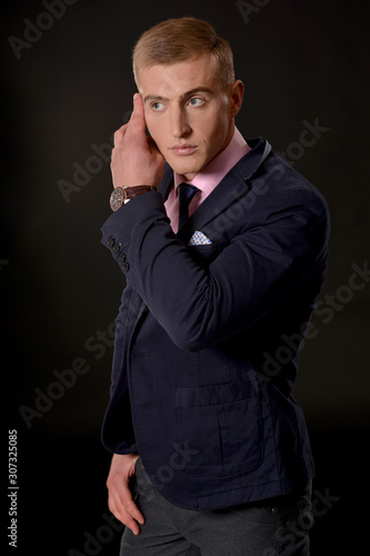 Portrait of a young businessman posing in studio