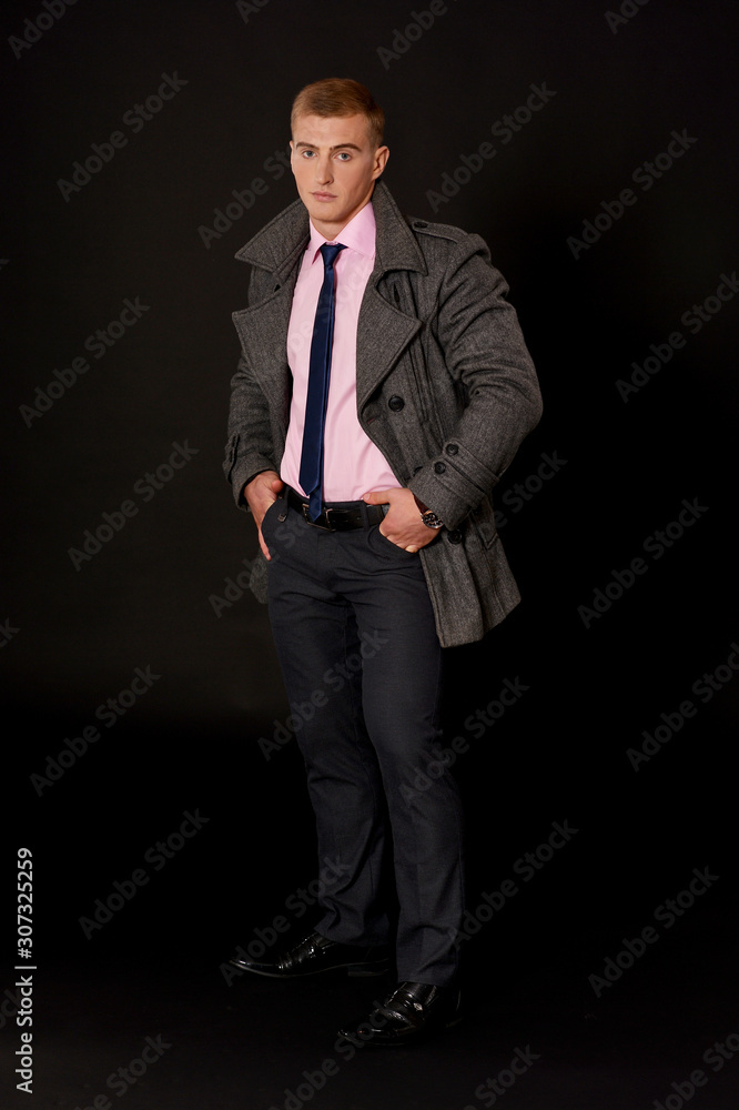 Portrait of a young businessman posing in coat Portrait of a young businessman posing in coat
