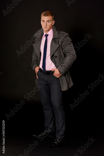 Portrait of a young businessman posing in coat © aletia2011