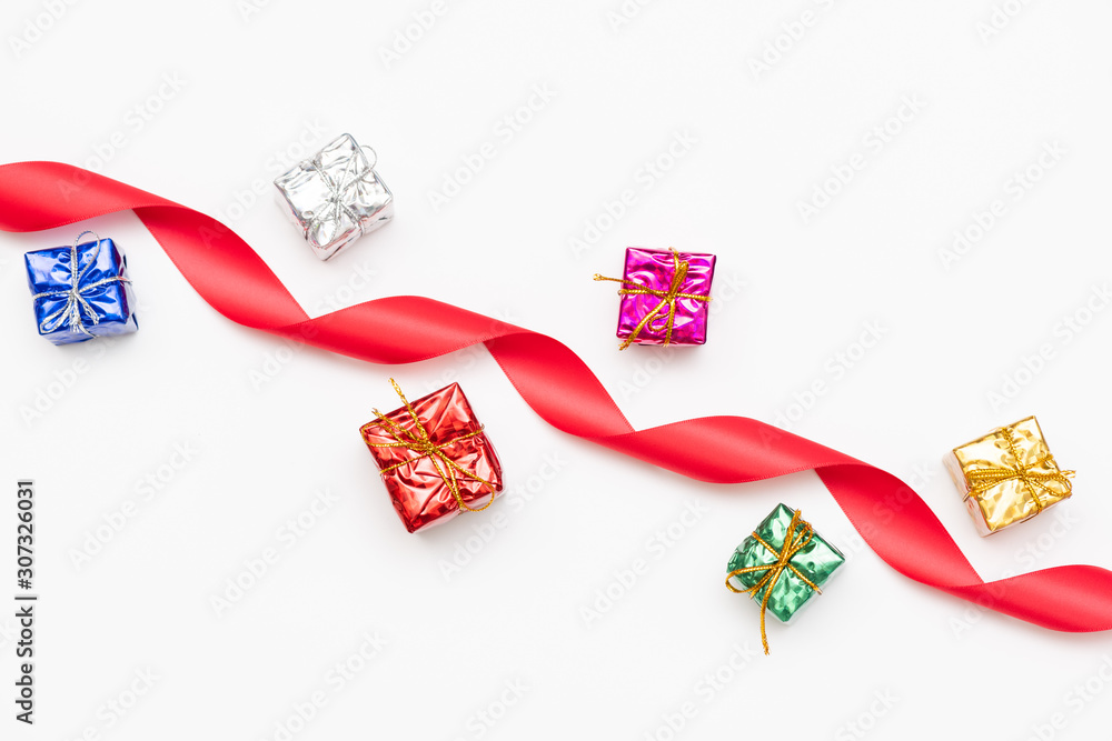 Merry Christmas card made of fir branches, gift boxes, red decoration, sparkles and confetti on white background. Merry Christmas card made of fir branches, gift boxes, red decoration, sparkles and confetti on white background.