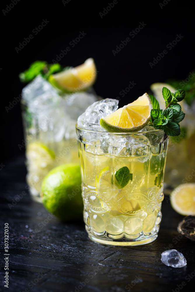 Fototapeta premium Cold tea with ice, mint and lime