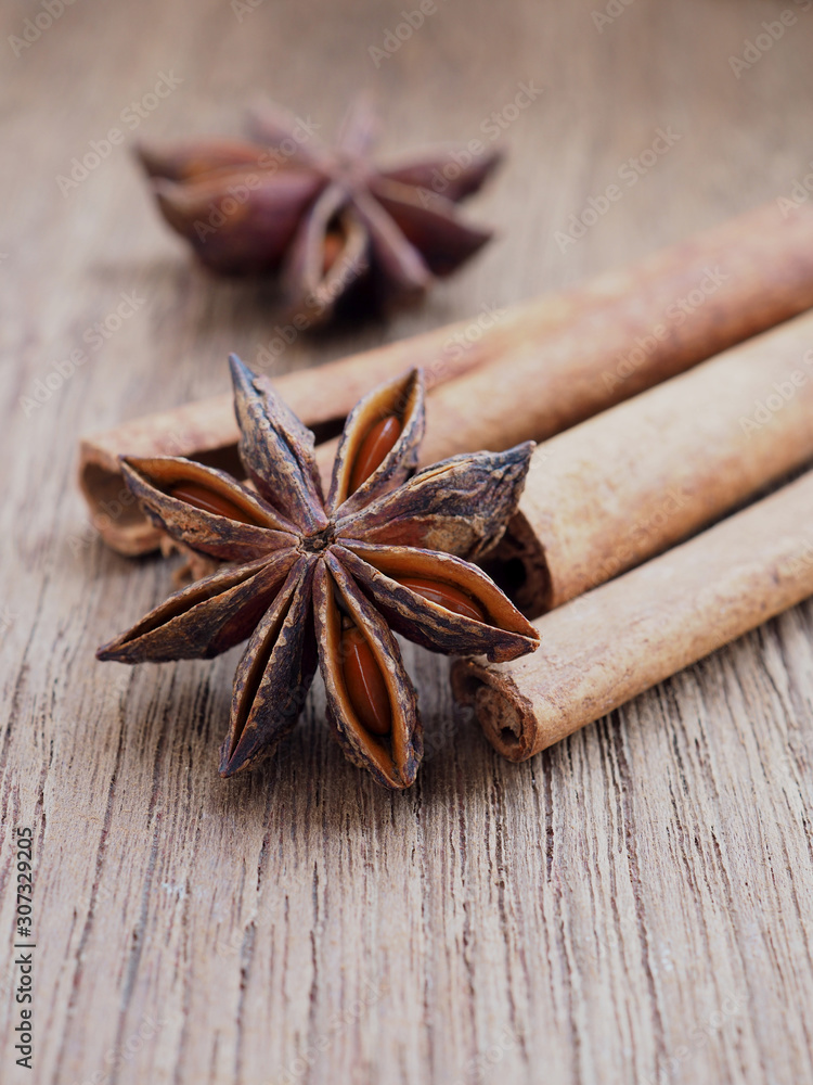 Dried anise and cinnamon on wooden background. Close up. Dried anise and cinnamon on wooden background. Close up.
