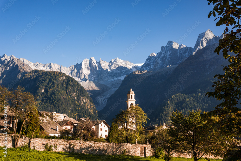 The Swiss Alps at sunset in the Bregaglia valley, near the village of Soglio, Switzerland - October 2019. The Swiss Alps at sunset in the Bregaglia valley, near the village of Soglio, Switzerland - October 2019.