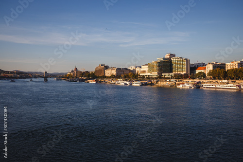 Landscapes of the buildings and harbor with boats beside Danube River in Budapest