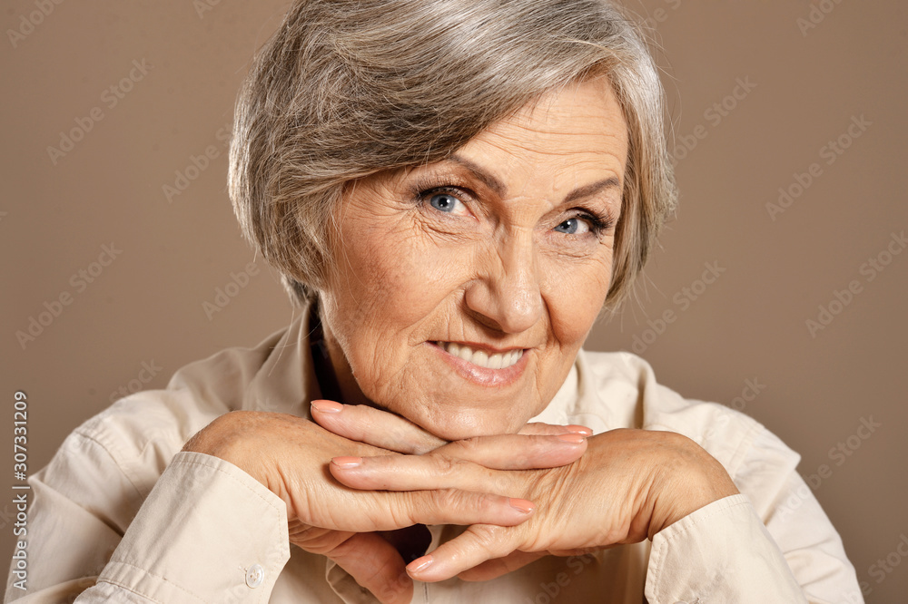 Close up portrait of happy beautiful smiling senior woman posing Close up portrait of happy beautiful smiling senior woman posing