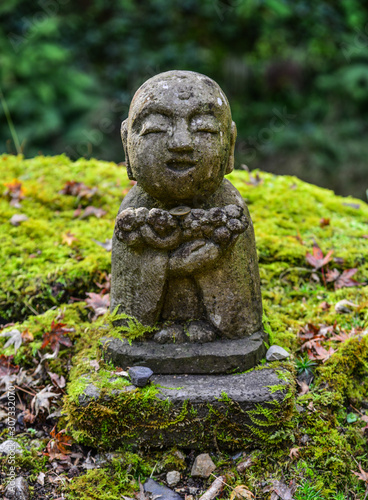 Stone statue of smiling Jizo Bosatsu