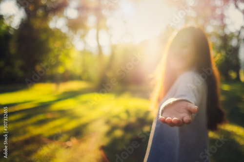 Bild auf Leinwand Follow me, a beautiful asian woman holding hands and leads into the park before