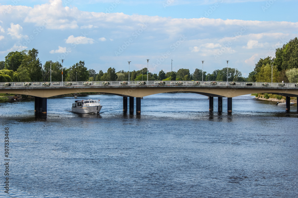 Karlstad bridge with tourist boat under the bridge in the river Klarälven, Sweden