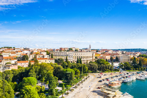 Croatia, Istria, city of Pula, panoramic view of ancient Roman arena, historic amphitheater and old town center from drone