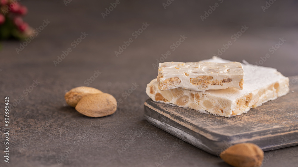 El Turron de Alicante or The nougat of Alicante made with lightly roasted whole almonds and honey. Popular Spanish Christmas sweet. El Turron de Alicante or The nougat of Alicante made with lightly roasted whole almonds and honey. Popular Spanish Christmas sweet.