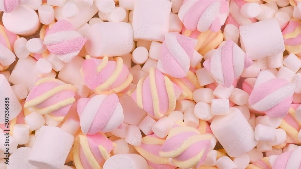 Marshmallow. Close-up of Marshmallows colorful chewy candy backdrop, rotation over pink background. Sweet food dessert in a cup with hot chocolate closeup. Top view, flatlay. 4K UHD video Marshmallow. Close-up of Marshmallows colorful chewy candy backdrop, rotation over pink background. Sweet food dessert in a cup with hot chocolate closeup. Top view, flatlay. 4K UHD video