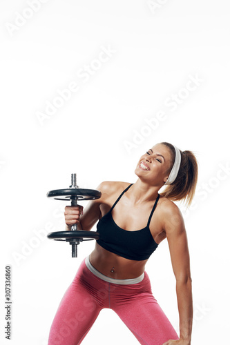 young woman exercising with dumbbells © SHOTPRIME STUDIO