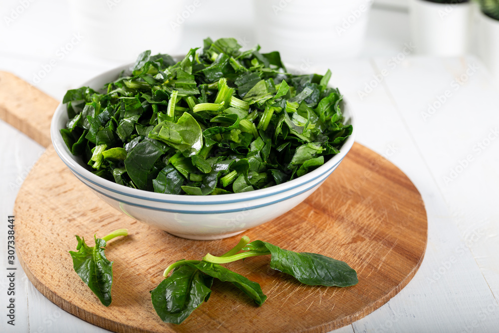 Chopped fresh spinach in a bowl Chopped fresh spinach in a bowl