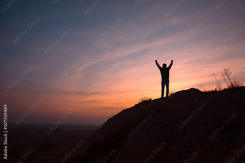 man in mountain at the sunset