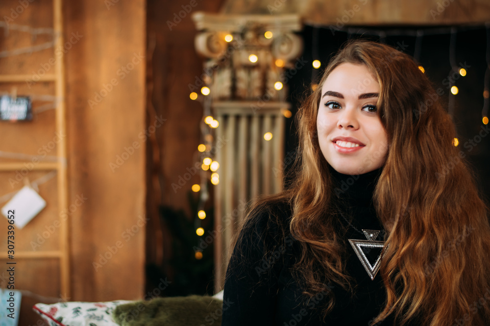 Portrait of girl on fireplace background with garlands. bokeh. Christmas studio photo. Portrait of girl on fireplace background with garlands. bokeh. Christmas studio photo.