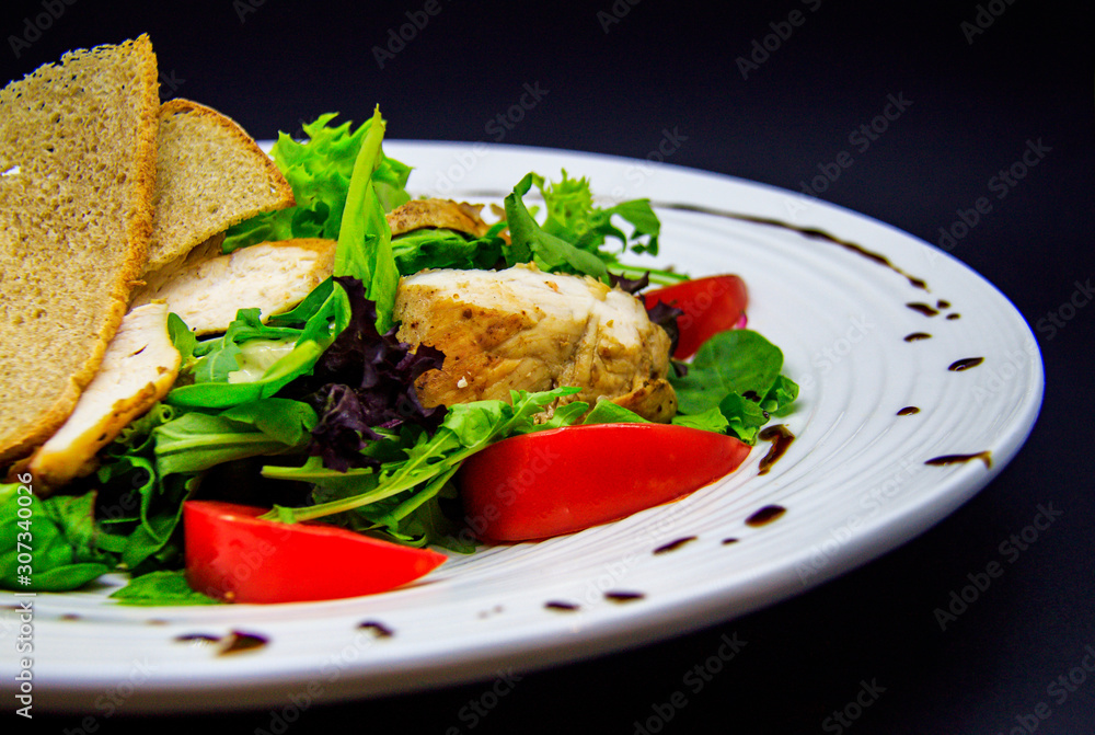 Caesar salad on black background