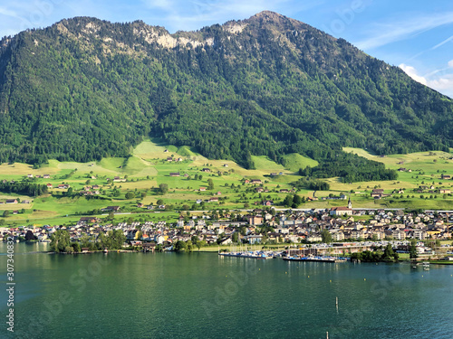 Settlement Buochs on the shores of Lake Luzerne or Vierwaldstaettersee (Vierwaldsattersee), at the end of the Engelbergertal Valley and Mountain Buochserhorn - Canton of Nidwalden, Switzerland photo