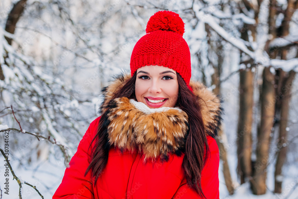 Outdoor close-up portrait of young beautiful happy smiling girl wearing red knitted hat, and coat . Outdoor close-up portrait of young beautiful happy smiling girl wearing red knitted hat, and coat .