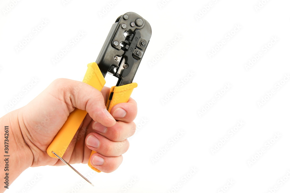 hand holding twisted pair crimping tool on white background with copy space hand holding twisted pair crimping tool on white background with copy space