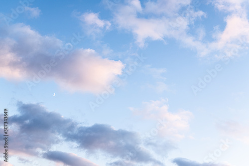 Scenic view of blue sky with clouds and moon at sunset