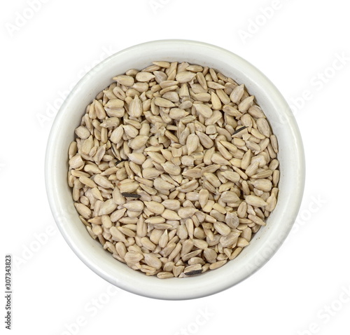 sunflower seeds in a white bowl isolated on white