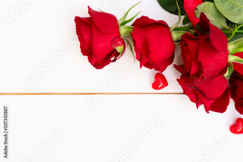 Red blooming roses on wood