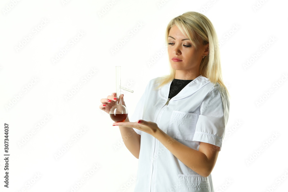 female lab technician in a white coat holding a flask with a reagent female lab technician in a white coat holding a flask with a reagent