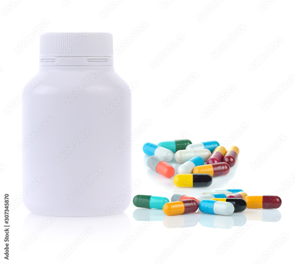 White plastic medicine bottle and medical capsules on white background. White plastic medicine bottle and medical capsules on white background.