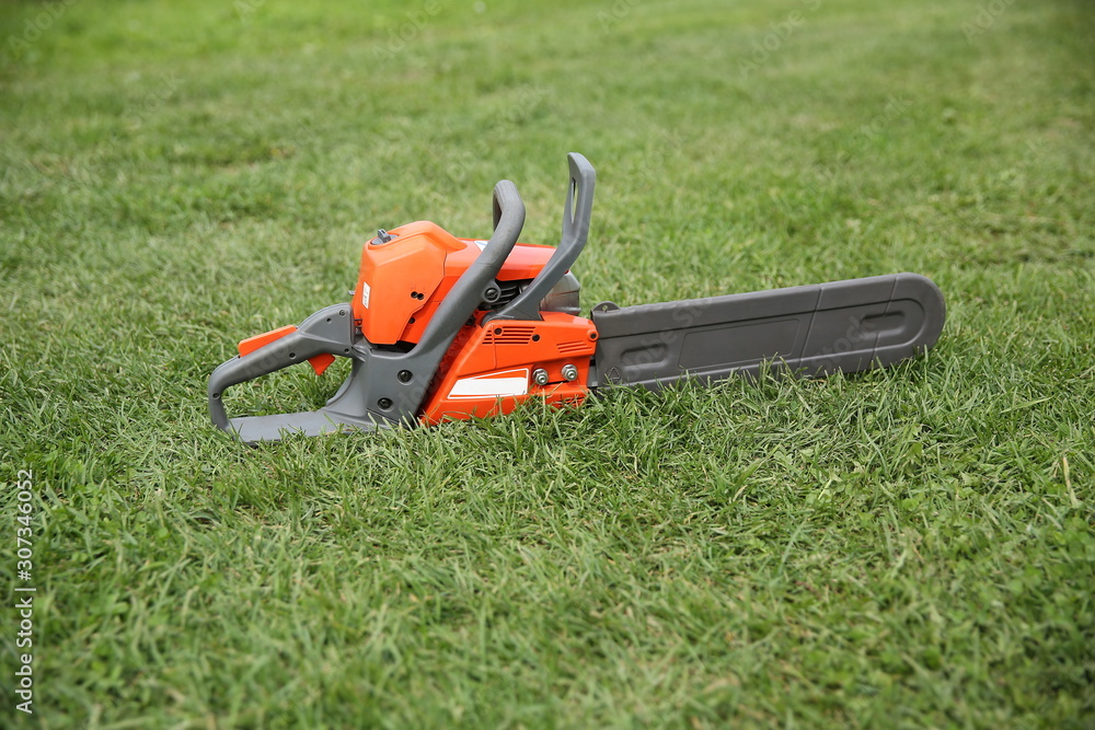 background of chainsaw on the grass with copy space