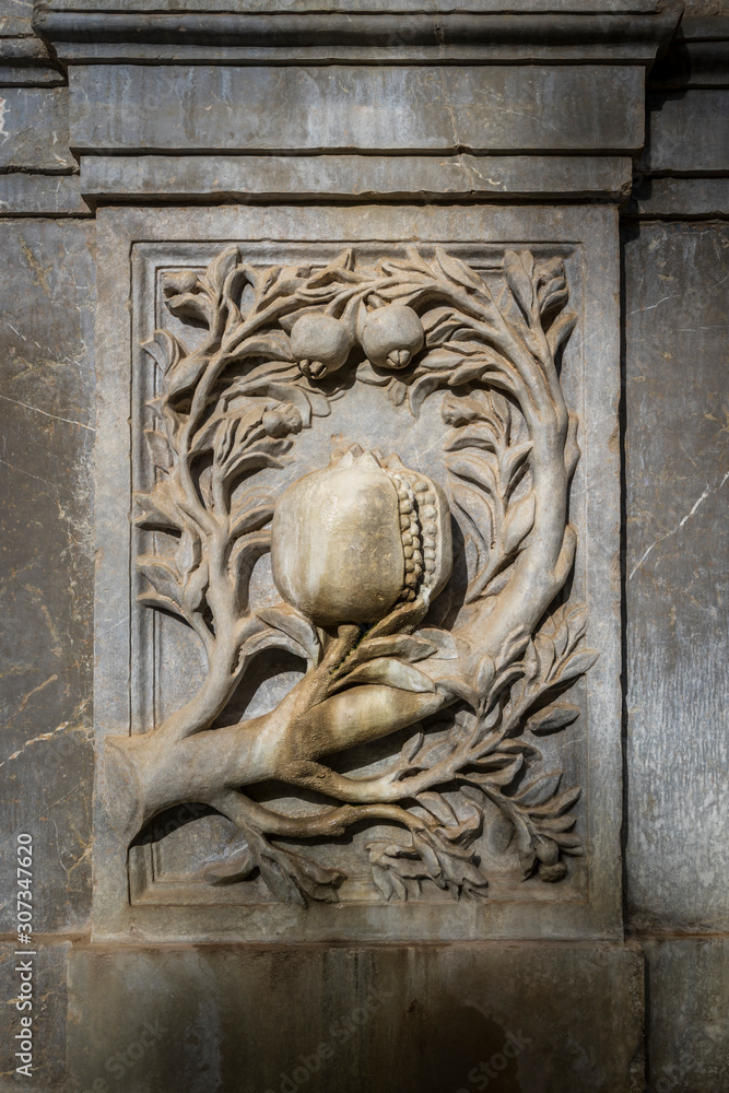 Pomegranate fruit carved in stone, emblem of the city Granada, Spain.
