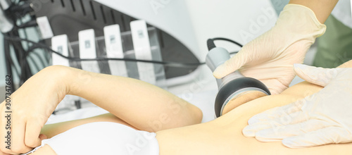 Cavitation rf body treatment. Female ultra sound lipo machine. Spa contouring. Doctor hands