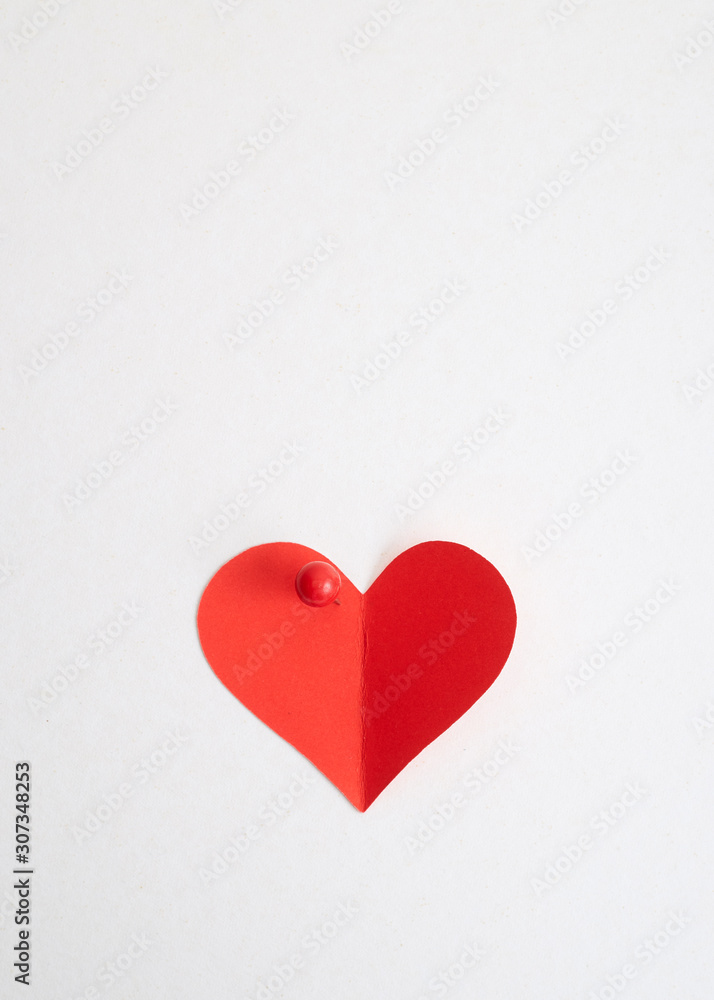 Red heart paper with red pin Red heart paper with red pin