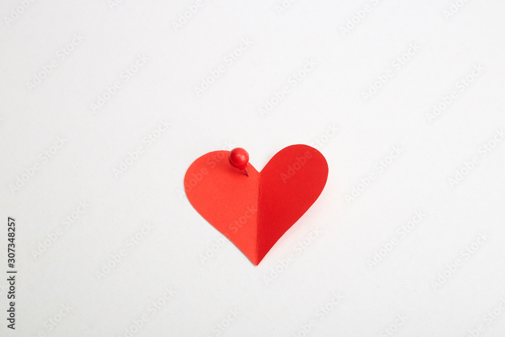 Red heart paper with red pin Red heart paper with red pin